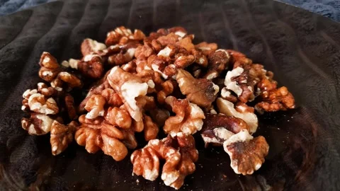 A close-up of shelled walnuts ready to eat on a plate. Stock Footage 316638984