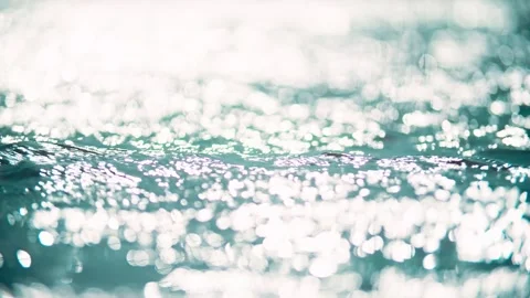 Close-up of shimmering light spots and ripples on the lake surface. Stock Footage 345580191