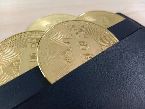 Close-up of shiny Bitcoins inside a wallet Stock Photos