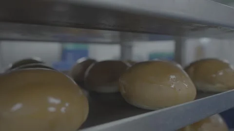 Close up of shiny brown buns cooling in professional bakery kitchen 스톡 동영상 327073057