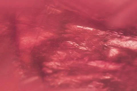 Close-up of shiny, crumpled red plastic with reflective surface, creating a.. Stock Photos
