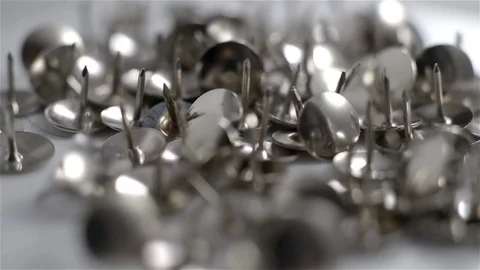 Close up of shiny metal pushpin rotating on white background Stock Footage 71973962