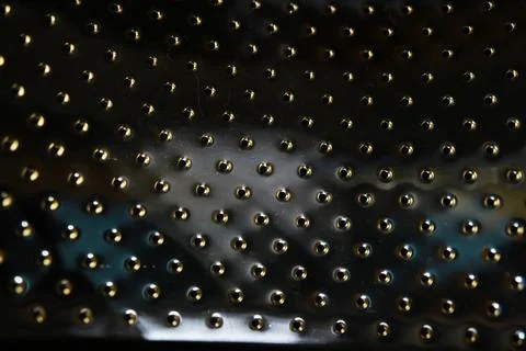 Close-Up of Shiny Metallic Surface with Rows of Small Circular Protrusions Stock Photos