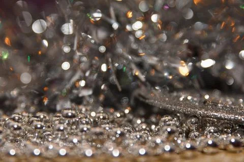 Close-up of shiny silver beads and tinsel. Scene features a blurred backgro.. Stock Photos