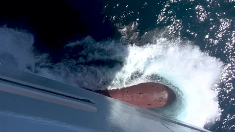 Close-up of a ship bulb bow cutting through ocean water with splashing motion. Stock Footage 332332139