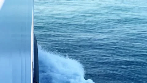 Close-up of a Ship Cutting Through Ocean Waves Creating White Foam 库存影片 329921541