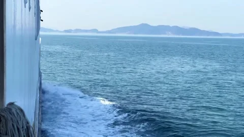Close-up of a Ship Cutting Through Ocean Waves Creating White Foam 库存影片 329921566