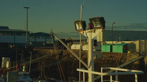 Close-up of ship mast with LED floodlights at harbor with golden sunrise an.. Stock Footage 328460920