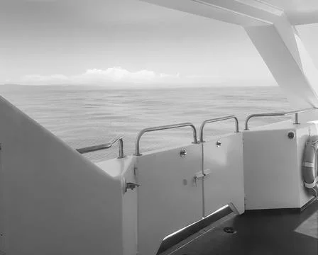 Close-up of the ship's side, the view from the deck of the yacht at dawn on t Stock Photos