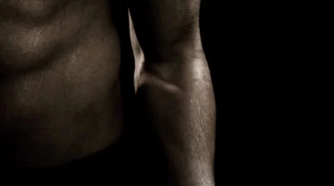 Close up of a shirtless man doing bicep curls Video stock 33831219