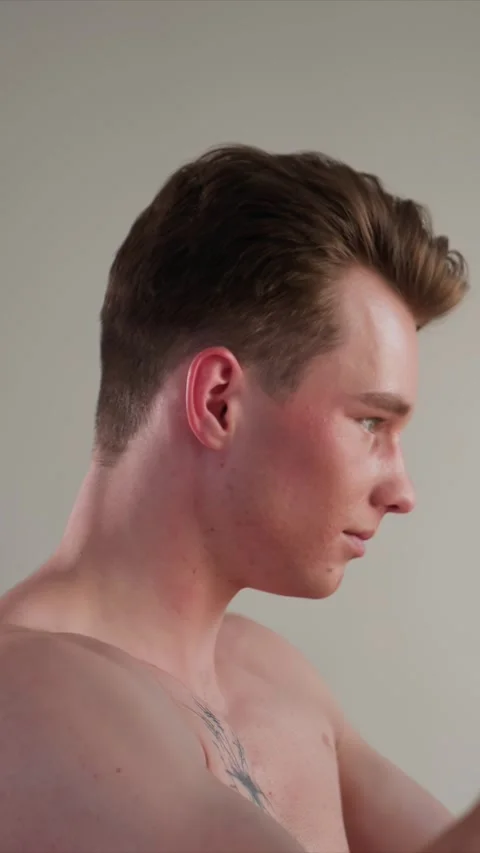 Close up of shirtless young man with short brown hair abstract chest tattoo Stock Footage 344411988