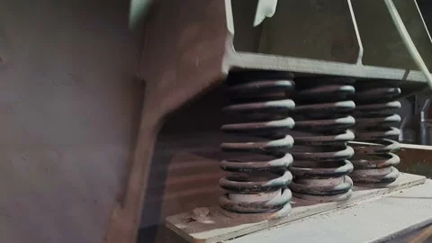 Close-up of shock absorbers of a machine for screening of bulk materials in work Stock Footage 150111345
