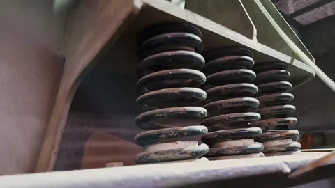 Close-up of shock absorbers of a machine for screening of bulk materials in work Stock Footage 150146499