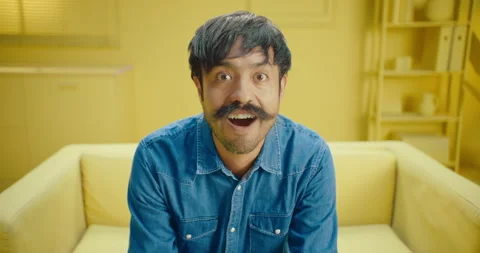 Close up of shocked hispanic man with mustache reading unbelievable news on Stock Footage 171446326