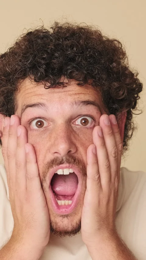 Close up, shocked man looking at the camera with big eyes, says wow, isolated on Stock Footage 252502014