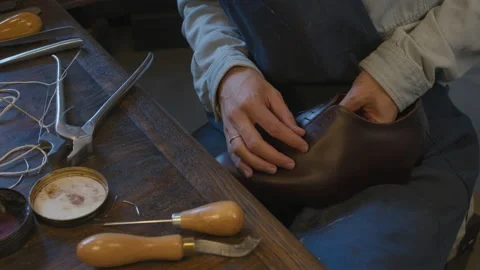 Close up shoemaker hands sews shoes. Shoe manufacturing workshop. Handmade work Stock-Footage 137400649
