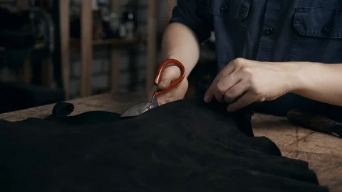 Close up of a shoemaker man working with leather using crafting tools in diy Stock Footage 95158107