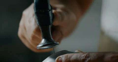 Close up of a shoemaker nailing and fixing the leather of the shoe. Stock Footage 114680075