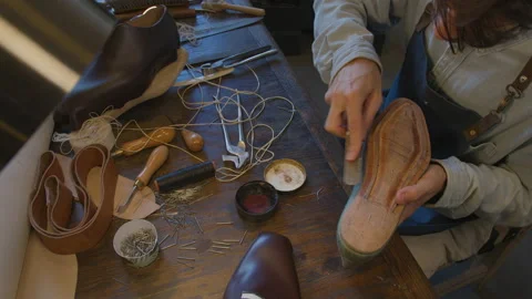 Close up shoemaker sews shoes to order. Shoe manufacturing workshop. Handmade Stock Footage 137404233