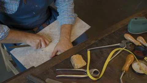Close up shoemaker sews shoes to order. Shoe manufacturing workshop. Handmade Stock Footage 137586989