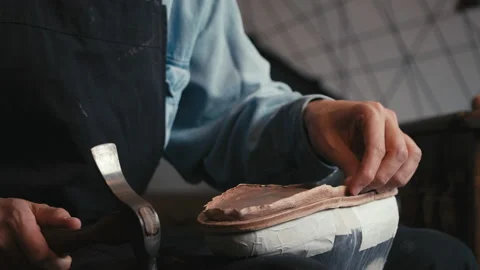 Close up shoemaker taps sole shoes with hammer. Workshop for production shoes Stock Footage 138234209