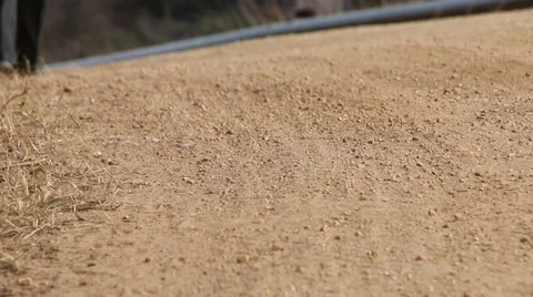 Close up of shoes and legs walking on dirt road Stock Footage 48239394
