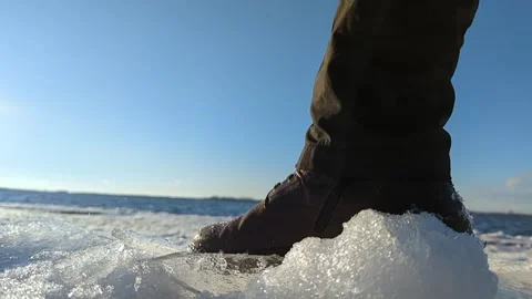 Close-up of shoes breaking on fresh ice sparkling in the sun Stock Footage 254433319