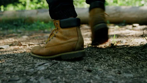 Close-up of shoes, man jumping on the ground, walk in nature 4K. Stock Footage 234573103