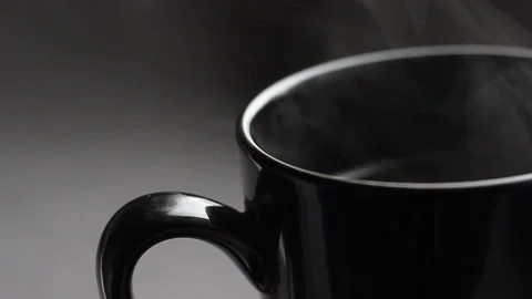 Close up shoot with black cup of coffee. The white smoke on the background Video stock 86011145