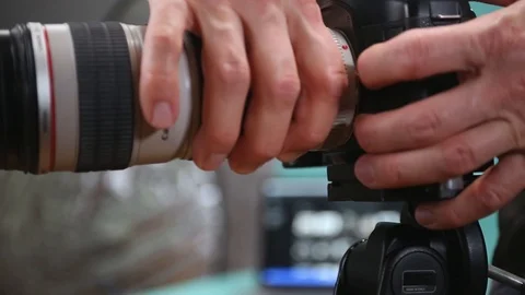 Close-up shoot on a man's hands changing lenses. Video stock 127525194