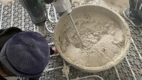 Close up. Shoot of mixing concrete using an electric mixer. Video stock 229499878