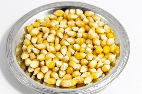 Close shoot of multiple corn seeds in the metal reflective cup Stock Photos