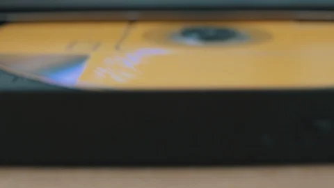 Close-up shoot of a person ejecting a cd from a portable device. Video stock 123721789