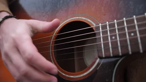 Close shoot of playing on old guitars's strings. Stock Footage 151329801