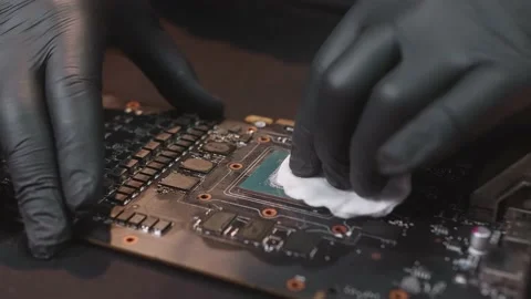 Close shoot of removing a thermal grease from a central processor in socket Stock Footage 162501731