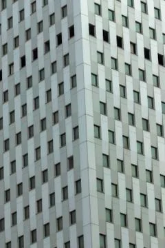 Close-up shoot of white-colored high-rise office building with ordinary facad Stock Photos