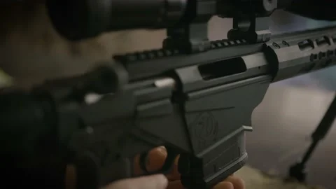 Close up on shooter loading magazine to Ruger precision rifle Stock Footage 146942153