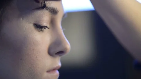Close up shooting face Make-up artist doing makeup black eyebrows model before Stock Footage 78630981