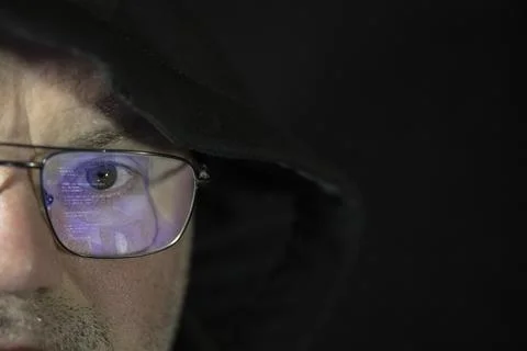Close-up shooting of a hacker working on a computer for a cyber attack. Stock Photos