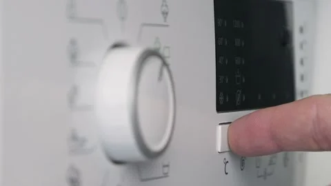 Close Up Shooting with a Hand Setting the Laundry Machine Function Mode.  動画素材 157858386