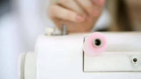 Close-up shooting hands putting pink thread in sewing machine Video stock 74155262