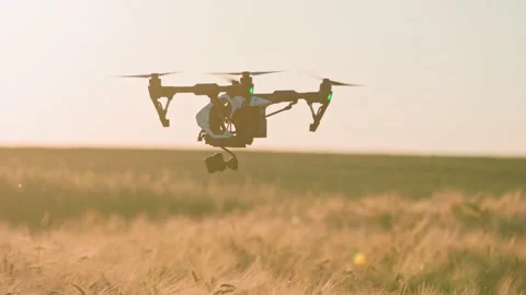 Close-up shooting of modern quadcopter with digital video camera flying over Stock Footage 207756049