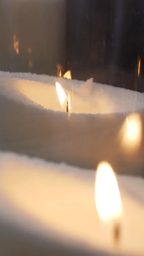 Close up shooting of a multitude of burning candles in large glass vases Stock Footage 294985349
