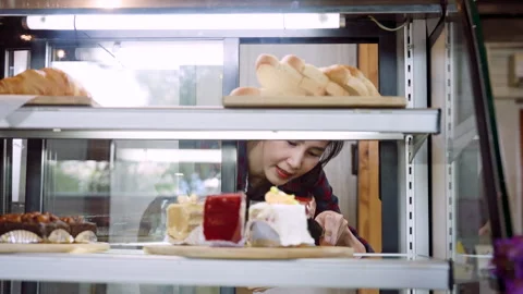 Close-up shop owner down use keep, picking up cakes from bakery cabinet, Stock Footage 244939742