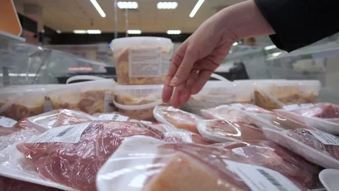 Close-up shopper choosing package fresh meat in store. Stock Footage 282122970