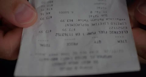 Close-Up of Shopper Hands Holding Long Printed Receipt... Stock Footage 329253718