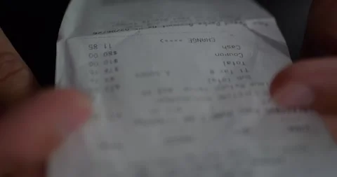 Close-Up of Shopper Hands Holding Printed Receipt. Prices... Vidéo 329253716