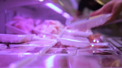 Close-up shopper selecting packaged meat from store shelf. Shelf offers wide Stock Footage 278508448