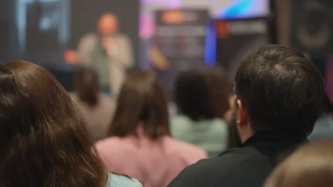 Close-up short of backs of people's heads at conference. Men and women looking Video stock 269004774