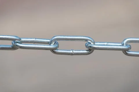 Close-up of short-link welded galvanized chain. Stock Photos